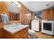 Bathroom and laundry area features wood paneling and updated appliances at 3808 22Nd Street Ne Ct, Hickory, NC 28601
