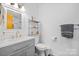 The bathroom has a modern sink and mirror with a towel rack and shelving unit for storage at 3808 22Nd Street Ne Ct, Hickory, NC 28601