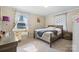 This bedroom has a writing desk, a queen-sized bed, and a large window with decorative curtains at 3808 22Nd Street Ne Ct, Hickory, NC 28601