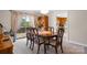 The dining room has a wooden table and chairs with a floral centerpiece, with a view to a wood deck at 3808 22Nd Street Ne Ct, Hickory, NC 28601