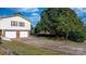 Wide driveway leading to a two-car garage with a well-maintained lawn and mature tree providing shade at 3808 22Nd Street Ne Ct, Hickory, NC 28601