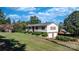 Split-level home with a two-car garage, brick accents, and mature trees surrounding the property at 3808 22Nd Street Ne Ct, Hickory, NC 28601