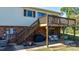 Exterior view showcasing a deck with stairs and lower level patio, set against a brick foundation at 3808 22Nd Street Ne Ct, Hickory, NC 28601