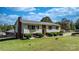 Well-kept home with green lawn, brick chimney, and lush surrounding trees at 3808 22Nd Street Ne Ct, Hickory, NC 28601