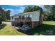 View of the house with a spacious wooden deck and ground level patio, perfect for enjoying outdoor living at 3808 22Nd Street Ne Ct, Hickory, NC 28601