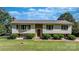 Charming split-level home boasts a well-manicured front lawn with mature landscaping at 3808 22Nd Street Ne Ct, Hickory, NC 28601