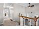 Hallway with staircase, neutral walls, ceiling fan, and carpeted floor at 3808 22Nd Street Ne Ct, Hickory, NC 28601