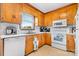 Functional kitchen with white appliances, wooden cabinets, and a window over the sink at 3808 22Nd Street Ne Ct, Hickory, NC 28601