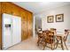 Eating area with wooden cabinets, a white refrigerator, and a table with chairs at 3808 22Nd Street Ne Ct, Hickory, NC 28601
