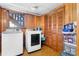 Laundry area with modern washer and dryer, wood paneling, and storage at 3808 22Nd Street Ne Ct, Hickory, NC 28601