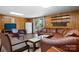 Basement area featuring wood paneling, furniture, and sliding door to the backyard at 3808 22Nd Street Ne Ct, Hickory, NC 28601