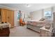 A well lit main bedroom with a floral bedspread, a large window and classic decor at 3808 22Nd Street Ne Ct, Hickory, NC 28601