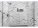 Close-up view of the marble-tiled shower with a rainfall shower head and built-in niche at 3808 22Nd Street Ne Ct, Hickory, NC 28601