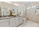 Modern bathroom featuring dual vanities, a glass-enclosed shower, and stylish finishes at 407 Sunharvest Ln, Indian Trail, NC 28079