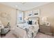 Comfortable bedroom with a floral bedding, neutral paint, and decorative wall decor at 407 Sunharvest Ln, Indian Trail, NC 28079