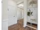 Welcoming entryway with hardwood floors, coat rack and storage, flowing seamlessly into the home at 407 Sunharvest Ln, Indian Trail, NC 28079