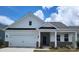 Charming single-story home featuring a two-car garage and inviting front porch at 407 Sunharvest Ln, Indian Trail, NC 28079