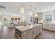 Open concept kitchen with oversized center island, adjacent to a spacious living area at 407 Sunharvest Ln, Indian Trail, NC 28079