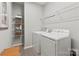 Functional laundry room equipped with washer, dryer, and storage shelving at 407 Sunharvest Ln, Indian Trail, NC 28079