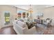 Inviting living room featuring large windows, stylish furnishings, and an open layout at 407 Sunharvest Ln, Indian Trail, NC 28079