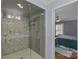 Modern bathroom with marble tiled shower and glass door, adjacent to the bedroom at 4300 Denbigh Dr, Charlotte, NC 28226