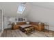 Spacious bonus room with skylight, ample seating, and stylish decor at 4300 Denbigh Dr, Charlotte, NC 28226