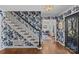 Entryway featuring hardwood floors, a staircase, and beautiful floral wallpaper at 4300 Denbigh Dr, Charlotte, NC 28226