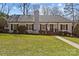 Charming single story home featuring a brick facade, manicured lawn, and beautiful landscaping at 4300 Denbigh Dr, Charlotte, NC 28226