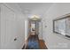 Bright hallway with hardwood floors, crown molding, and access to multiple rooms at 4300 Denbigh Dr, Charlotte, NC 28226