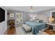 Relaxing primary bedroom with plush bedding, shuttered window, and elegant furnishings at 4300 Denbigh Dr, Charlotte, NC 28226