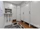 Well-organized mudroom with built-in cabinets, drawers, bench, and herringbone floors at 4300 Denbigh Dr, Charlotte, NC 28226