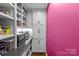 Well-organized pantry with custom shelves, cabinets, countertop, microwave, and stylish backsplash at 4300 Denbigh Dr, Charlotte, NC 28226