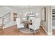 Well-lit dining area with a round wooden table, elegant white chairs, and a decorative mirror at 4775 Formation Dr # 99, Lancaster, SC 29720