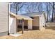Backyard view of the home featuring siding and two entry doors at 4836 Cheviot Rd, Charlotte, NC 28269