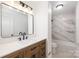 Modern bathroom featuring tile flooring, updated fixtures, and a marble-tiled shower at 4836 Cheviot Rd, Charlotte, NC 28269