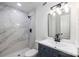 Updated bathroom featuring a marble tiled shower and new fixtures at 4836 Cheviot Rd, Charlotte, NC 28269