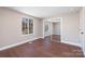 Bedroom with hardwood floors, natural light, and closet with mirrored doors at 4836 Cheviot Rd, Charlotte, NC 28269