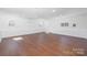 Spacious bonus room features hardwood floors, natural light and neutral paint scheme at 4836 Cheviot Rd, Charlotte, NC 28269