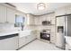 Modern kitchen features updated appliances, white cabinets, and a farmhouse sink at 4836 Cheviot Rd, Charlotte, NC 28269
