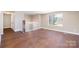 Bright, open room features hardwood floors, with staircase access at 4836 Cheviot Rd, Charlotte, NC 28269
