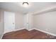 Finished room with hardwood floors, white trim, and neutral paint at 4836 Cheviot Rd, Charlotte, NC 28269