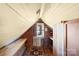 Attic space features wooden beams, built-in storage, and a cozy nook with an oriental rug at 4928 Tuckaseegee Rd, Charlotte, NC 28208