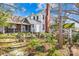 A two-story house showing a covered back porch, garden, and a well at 4928 Tuckaseegee Rd, Charlotte, NC 28208