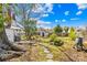 A well-maintained backyard features a shed, bench, garden and stone pathway at 4928 Tuckaseegee Rd, Charlotte, NC 28208