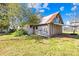 Side view of a weathered barn with peeling white paint and a rustic metal roof at 4928 Tuckaseegee Rd, Charlotte, NC 28208
