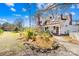 Side view of a charming white two-story home, featuring a front porch and beautifully landscaped yard at 4928 Tuckaseegee Rd, Charlotte, NC 28208