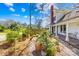 Brick pathway through a lush garden with potted plants and a view of the home's exterior at 4928 Tuckaseegee Rd, Charlotte, NC 28208