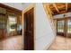 Open interior featuring a wooden staircase, multiple doors, and hardwood floors at 4928 Tuckaseegee Rd, Charlotte, NC 28208