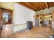 Spacious open floor plan with hardwood floors, exposed beams, and views into other rooms at 4928 Tuckaseegee Rd, Charlotte, NC 28208