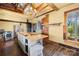Sunlit kitchen showcasing a central island with a wood countertop and custom cabinets at 4928 Tuckaseegee Rd, Charlotte, NC 28208